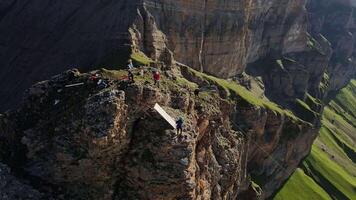 Drone surveying climbers setting up a springboard for rope jumping video