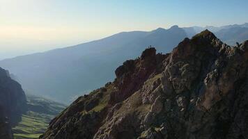 Aerial view of the climbers standing on top of the mountain video