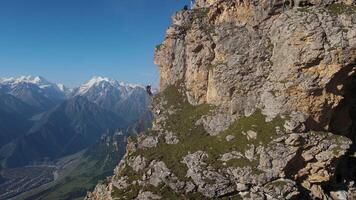 Aerial view climbers working with ropes to set up a springboard for rope jumping video