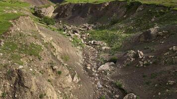 Aerial view of the mountain slope eroded by the stream. video