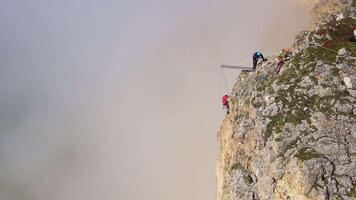 Aerial. mountain-climbers assembling a platform for jumping with rope video