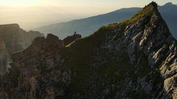 Aerial view of the summit with people and the green gorge with vertical walls video