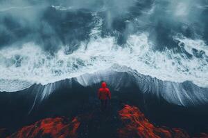 Solitude by the Sea Red-Clad Figure Overlooking Dramatic Ocean Waves photo