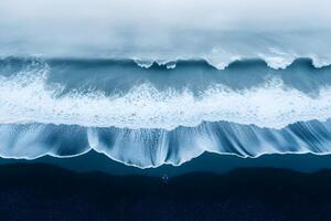 Serene Coastal View of Expansive Waves and Black Sand Beach from Above photo
