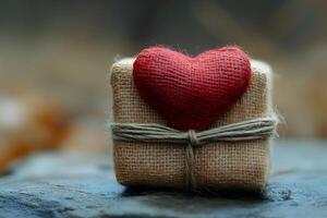 Rustic Gift Wrapped in Burlap with Red Heart for Valentine's Day or Romantic Occasions photo