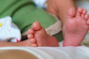 close up of baby feet, showcasing tiny toes and soft skin, evoking sense of innocence and warmth. Perfect for family or parenting themes photo