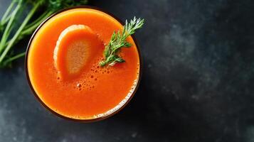 Fresh orange carrot juice garnished with slice and herb photo