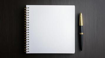 Blank notebook with pen on black background photo