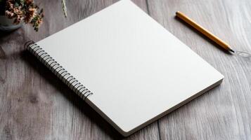 blank notebook page with pencil and plant nearby, ready for ideas photo