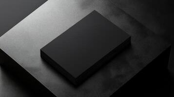 Minimalist black business cards stacked on textured surface photo