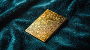A gold card with a flower design on it photo