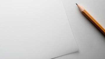A pencil and paper on a white surface photo