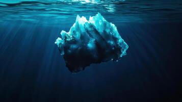 broken iceberg drifting in deep water with sunlight illuminating it photo