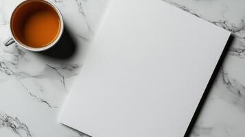 blank page on clean desk with cup of tea beside photo