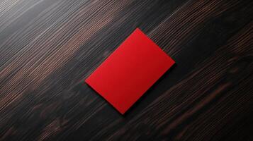 bold red card on dark wooden surface, creating striking contrast photo