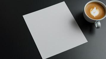 A blank sheet of paper and a cup of coffee on a black table photo