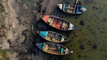 Three boats are docked in the water photo