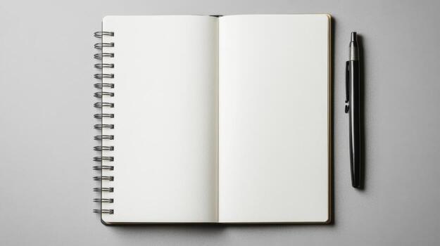 Blank notebook with pen on grey background photo