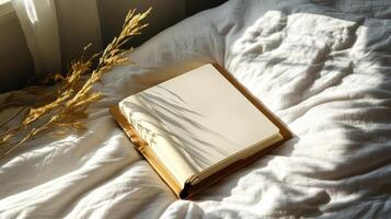 beautifully bound empty journal on soft bed with gentle sunlight photo