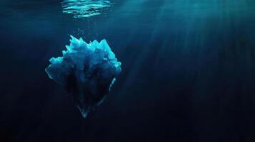 broken iceberg drifting in deep water with sunlight filtering through photo