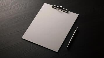 Blank clipboard with pen on black table photo