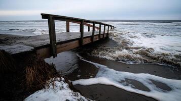 bridge partially collapsed due to rising tides and strong waves photo