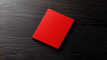 Bold red business card on dark wooden surface, perfect for branding photo
