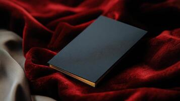 A black book on a red velvet cloth photo