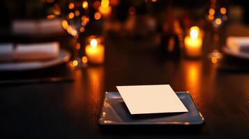 beautifully set dining table with blank card on plate, surrounded by candles photo
