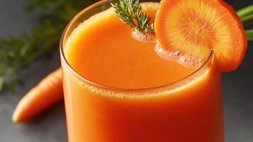 A glass of carrot juice with a garnish photo
