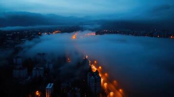 A city street is seen in the fog at night photo