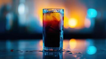 A glass of red liquid sitting on a table photo