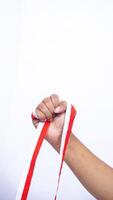 Clenched Fist with Red and White Ribbons on White Background photo