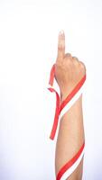 Man's Hand with Red and White Ribbons Showing Number One Sign on White Background photo