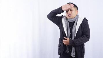 Sick Asian Man Measuring His Body Temperature on White Background photo