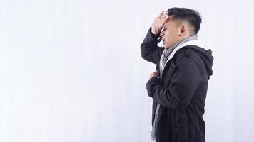 Side View of Sick Asian Man Measuring His Body Temperature on White Background photo