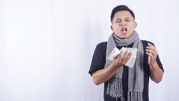 Asian Man Going to Sneeze Into Tissue Paper Suffering from Flu on White Background photo