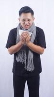 Sick Asian Man Sneeze Into Tissue Paper on White Background photo