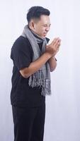 Side View of Sick Asian Man Going to Sneeze Into Tissue Paper on White Background photo