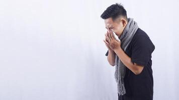 Side View of Unhealthy Asian Man Blows His Nose with Tissue Paper on White Background photo