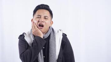 Young Asian Man Suffering from Toothache on White Background photo