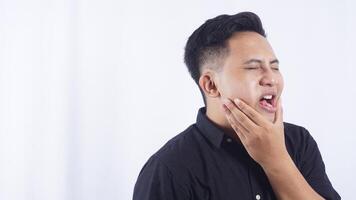 Unhealthy Young Asian Man with Toothache on White Background photo