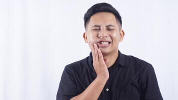 Unhealthy Young Asian Man with Swollen Cheek Suffering from Toothache on White Background photo
