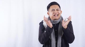 Sick Young Asian Man Touching His Cheek Suffering from Bad Toothache on White Background photo