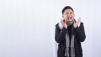 Sick Young Asian Man Touching His Swollen Cheek Suffering from Toothache on White Background photo