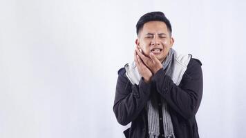 Young Asian Man Touching His Swollen Cheek Suffering from Toothache on White Background photo
