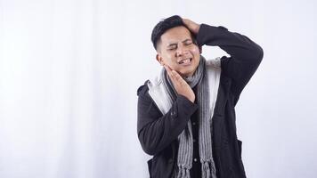 Sick Young Asian Man with Swollen Cheek Suffering from Toothache on White Background photo