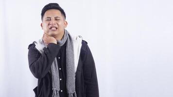 Young Asian Man Suffering from Strong Toothache on White Background photo