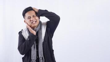 Sick Young Asian Man Suffering from Strong Toothache on White Background photo