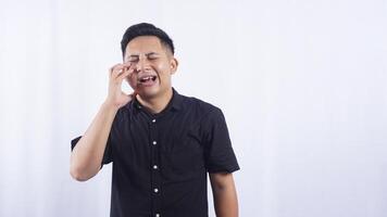 Unhealthy Young Asian Man Touching His Swollen Cheek Suffering from Toothache on White Background photo